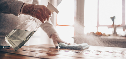 Close,Up,Of,Cleaning,Home,Wood,Table,,Sanitizing,Kitchen,Table