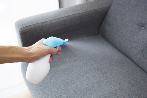Sprayed,Air,Freshener,In,Hand,On,Home,Interior,Background