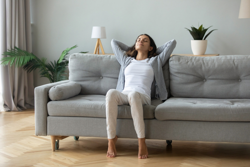 Happy,Millennial,Girl,Sit,Relax,On,Comfortable,Couch,In,Living