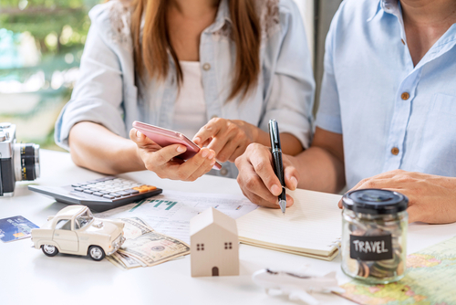 Young,Couple,Is,Planning,And,Managing,Home,Expenses,(house,,Car,