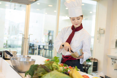 Asian,Female,Chef,In,Kitchen.,Cooking.,Restaurant.