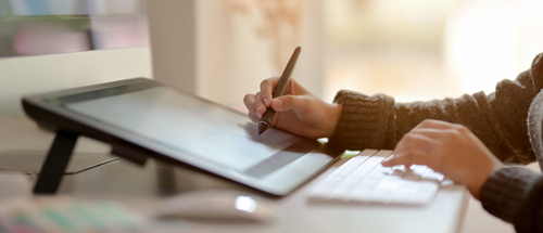 Side,View,Of,Female,Graphic,Designer,Working,On,Drawing,Tablet