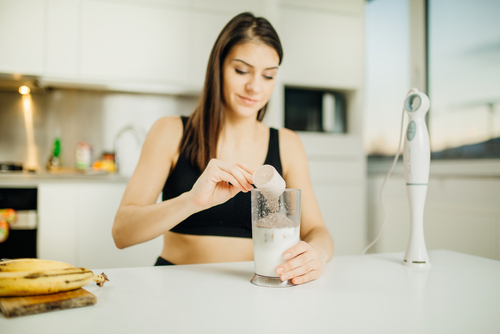 Woman,With,Immersion,Blender,Making,Banana,Chocolate,Protein,Powder,Milkshake