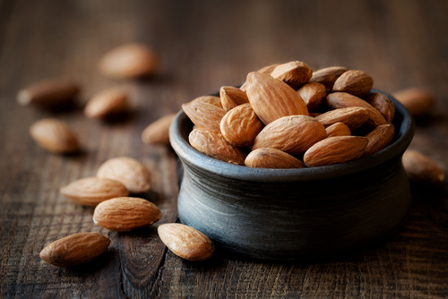 Almonds,In,A,Black,Bowl,Against,Dark,Rustic,Wooden,Background