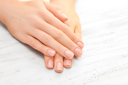 Woman,Hands,With,Beautiful,Manicure,On,Wooden,Background