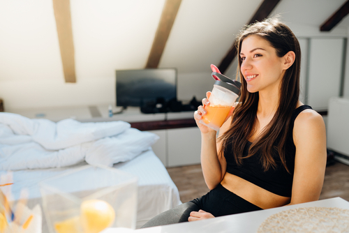 Woman,In,Sportswear,Drinking,Sweet,Orange,Amino,Acid,Powder,Smoothie