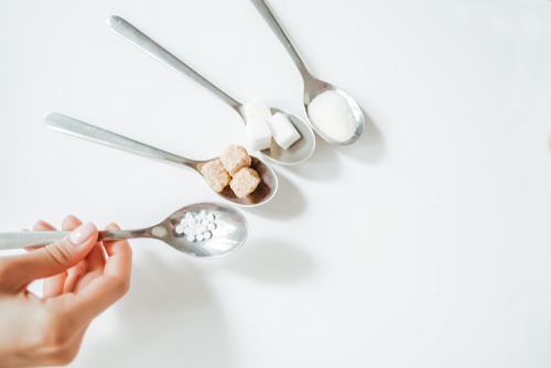 Different,Types,Of,Sugar,,The,Hand,Holds,A,Spoon,With