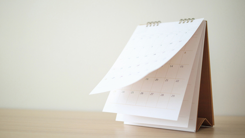 Calendar,Page,Flipping,Sheet,On,Wood,Table,Background,Business,Schedule