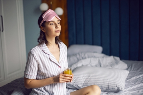 Woman,In,Striped,Pajamas,And,With,A,Sleep,Mask,Is