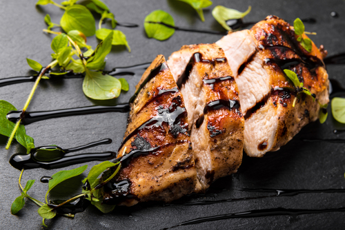 Roasted,Chicken,Breast,On,A,Black,Stone,Plate,With,Balsamic