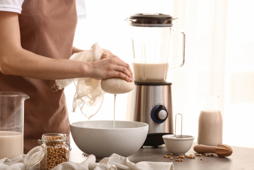 Woman,Making,Soy,Milk,In,Kitchen