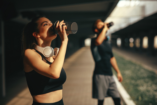 Young,Woman,And,Man,Drinking,Protein,Shake,After,Workout