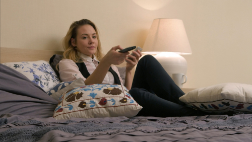 Young,Beautiful,Woman,Lying,On,The,Bed,,Turning,On,Tv