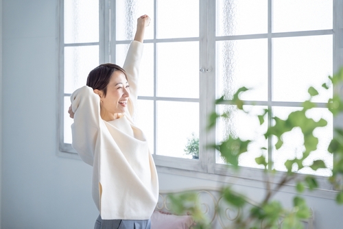Asian,Woman,Stretching,With,A,Smile