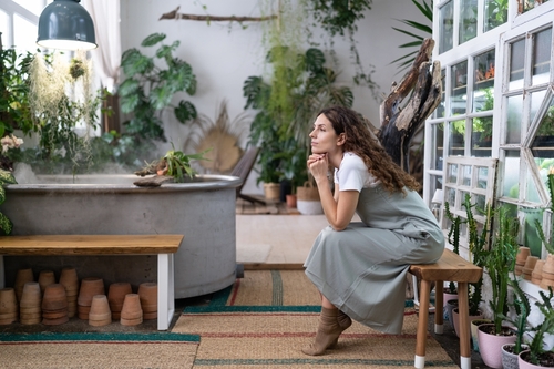Sad,Pensive,Woman,Sits,On,Bench,In,Home,Garden,,Thinking