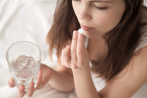 Unhealthy,Sick,Woman,Suffers,From,Insomnia,Or,Headache,,Takes,Sleeping