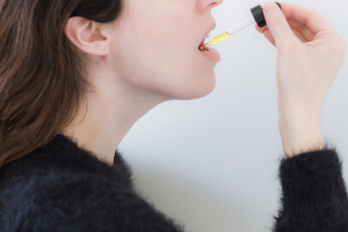 Woman,Taking,Cbd,Oil,Under,Tongue