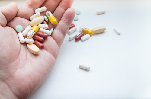 Assorted,Pills,And,Tablets,On,Hand,,Isolated,On,White,Background