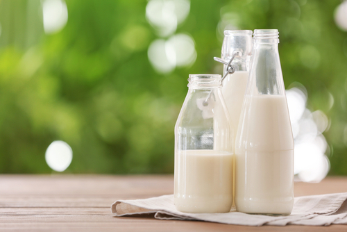 Bottles,Of,Fresh,Milk,On,Table,Outdoors