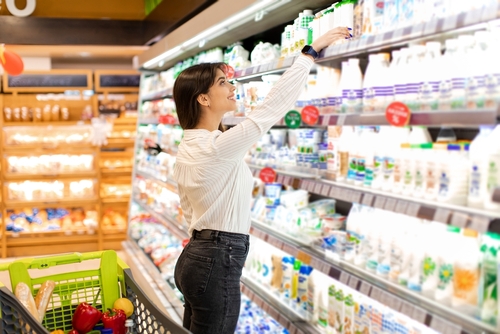 Middle,Eastern,Female,Taking,Dairy,Product,From,Shelf,Shopping,Groceries