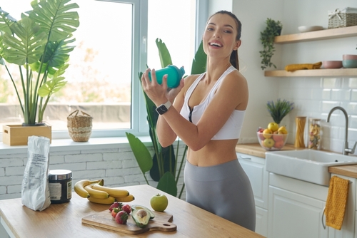 Happy,Young,Woman,In,Sports,Clothing,Preparing,Protein,Cocktail,At