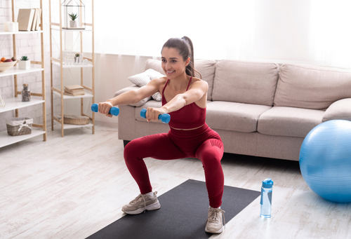 Indoor,Sports,Concept.,Strong,Young,Woman,Working,Out,With,Dumbbells