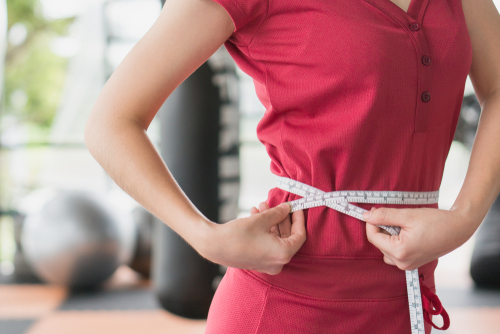 Young,Slim,Woman,Measuring,Her,Waist,By,Measure,Tape,After