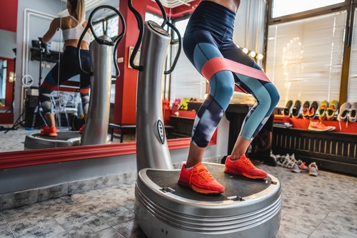 One,Woman,Training,On,The,Power,Plate,Machine,Female,Use