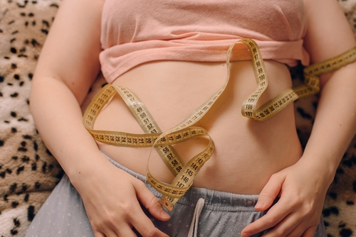 Overweight,Woman,With,Fat,Belly,And,Tape,Measure,On,It.