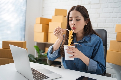 Asian,Businesswoman,Eating,Instant,Noodles,After,Hard,Work.,She,Is