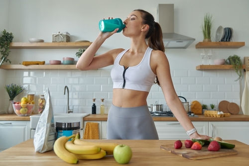 Confident,Young,Woman,In,Sports,Clothing,Drinking,Protein,Cocktail,While