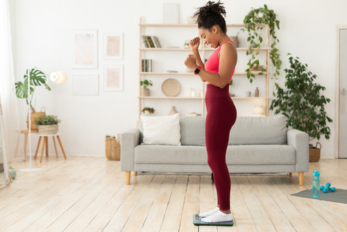 Joyful,Skinny,Black,Woman,Weighing,Herself,After,Successful,Dieting,And